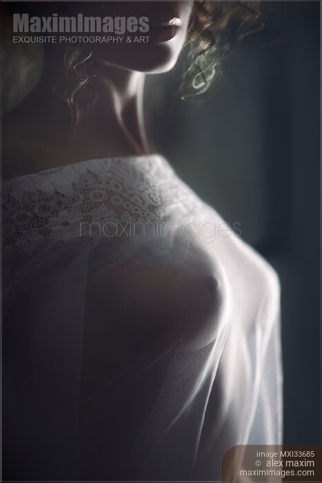 Sensual boudoir closeup of woman sexy breasts under sheer see-through white nightgown Stock photo of Sensual boudoir closeup of woman sexy breasts under sheer see-through white nightgown Buy commercial use license at MaximImages