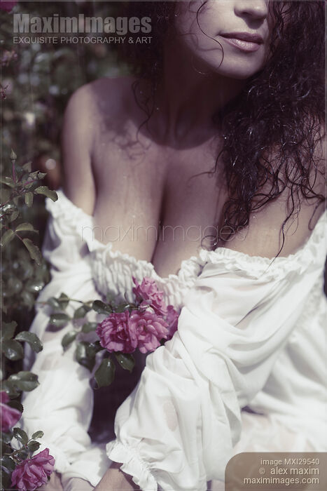 Sensual closeup of a woman with wet hair in rose garden in rain Stock photo of Sensual closeup of a woman with wet hair in rose garden in rain Buy commercial use license at MaximImages
