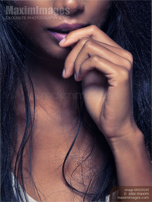 Stock photo of Sensual closeup of woman mouth biting her finger Buy commercial use license at MaximImages
