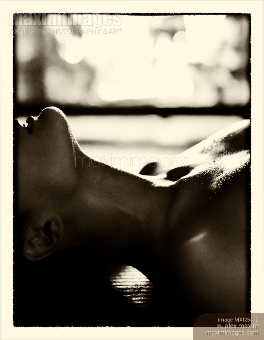 Stock photo of Sensual closeup of young woman making love in front of fireplace Buy commercial use license at MaximImages