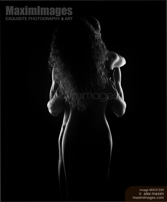Stock photo of Sensual nude couple standing in an embrace naked bodies silhouette black and white Buy commercial use license at MaximImages