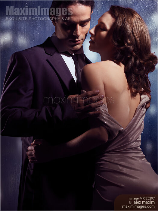 Sensual photo of couple standing near window on rainy night Stock photo of Sensual photo of couple standing near window on rainy night Buy commercial use license at MaximImages