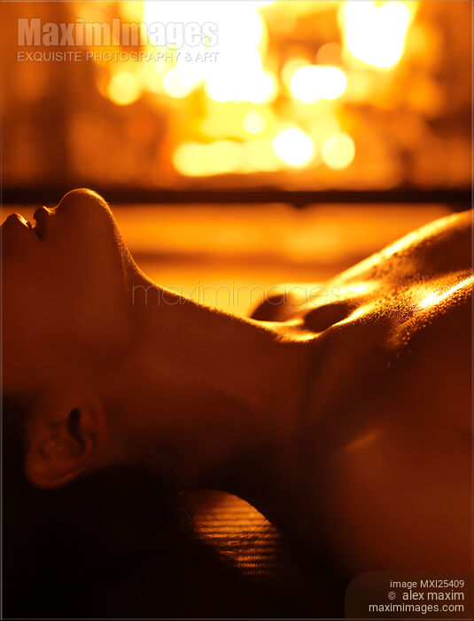 Stock photo of Sensual photo of Naked Woman in Front of Fireplace Buy commercial use license at MaximImages