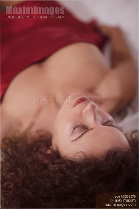 Sensual portrait of a beautiful woman closeup of face with closed eyes with delicate features lying in bed sleeping Stock photo of Sensual portrait of a beautiful woman closeup of face with closed eyes with delicate features lying in bed sleeping Buy commercial use license at MaximImages