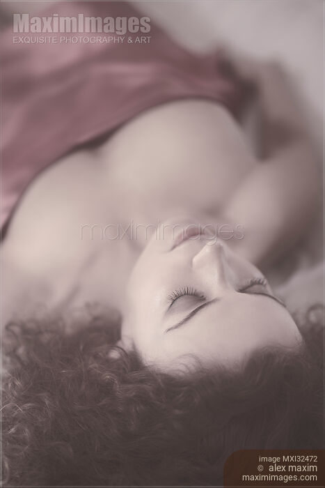 Sensual portrait of a beautiful woman with delicate features lying in bed sleeping closeup of face with closed eyes Stock photo of Sensual portrait of a beautiful woman with delicate features lying in bed sleeping closeup of face with closed eyes Buy commercial use license at MaximImages