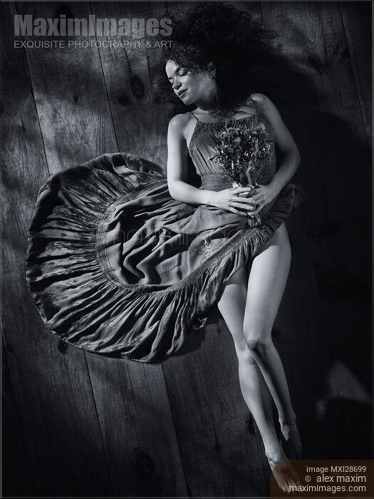 Sensual portrait of woman in dress with bare legs lying on the floor Black and white Stock photo of Sensual portrait of woman in dress with bare legs lying on the floor Black and white Buy commercial use license at MaximImages