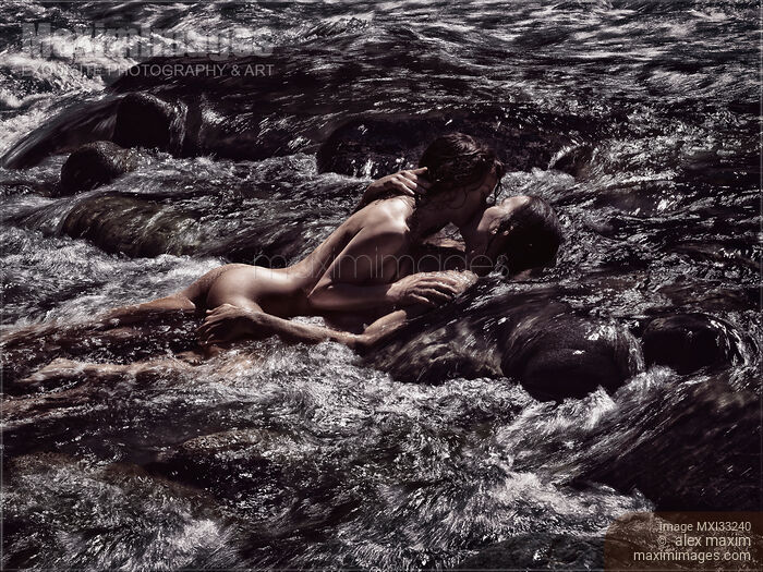 Stock photo of Sensual romantic nude couple in an embrace, kissing, making love in wild water of a river in nature Black and white Buy commercial use license at MaximImages