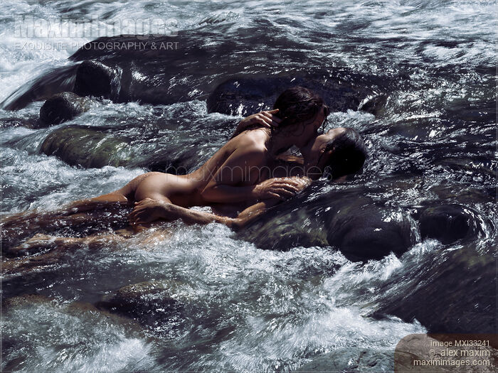 Stock photo of Sensual romantic nude couple in an embrace, kissing, making love in wild water of a river in nature scenery Buy commercial use license at MaximImages