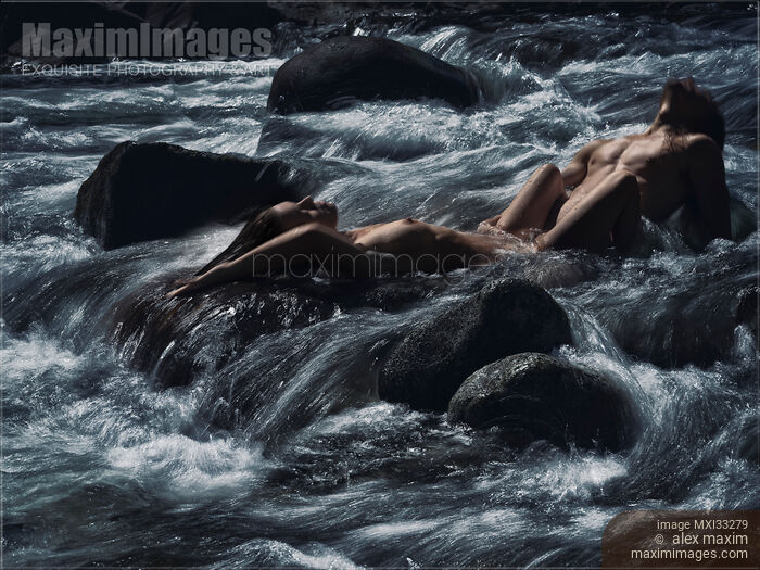 Sensual romantic nude couple making love in wild water of a mountain river in dramatic nature scenery Stock photo of Sensual romantic nude couple making love in wild water of a mountain river in dramatic nature scenery Buy commercial use license at MaximImages