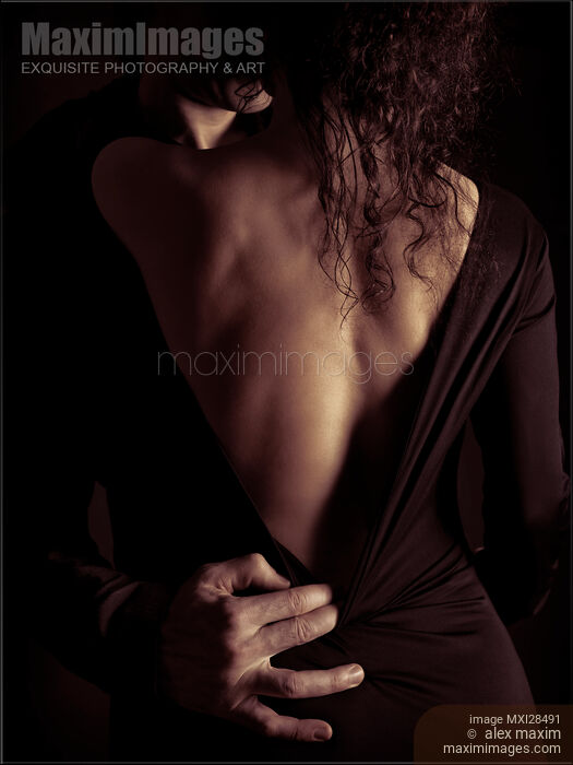 Sensual romantic portrait of a couple kissing in dim dramatic light Stock photo of Sensual romantic portrait of a couple kissing in dim dramatic light Buy commercial use license at MaximImages