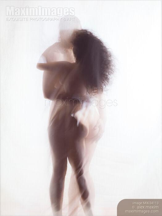 Sensual surreal photograph of a nude couple kissing in an embrace with their naked bodies behind sheer white veil Stock photo of Sensual surreal photograph of a nude couple kissing in an embrace with their naked bodies behind sheer white veil Buy commercial use license at MaximImages