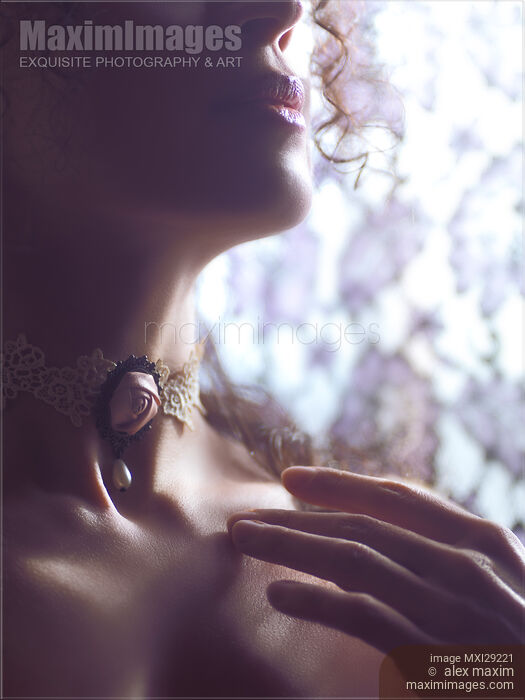 Stock photo of Sensual woman face with a rose choker on her neck Buy commercial use license at MaximImages
