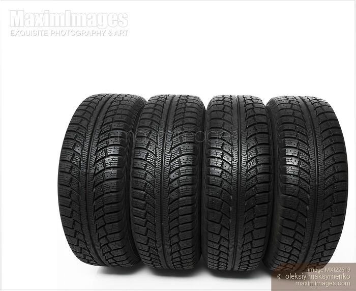 Stock photo of Set of four winter tires isolated on white background Buy commercial use license at MaximImages