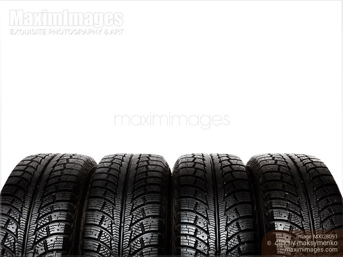 Stock photo of Set of snow tires isolated on white Buy commercial use license at MaximImages