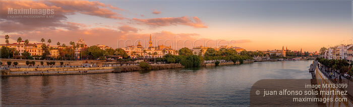 Stock photo of Seville Spain river Guadalquivir the Giralda Cathedral and the Gold tower sunset panorama Buy commercial use license at MaximImages