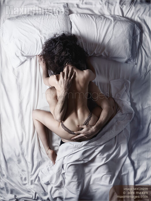 Sexy couple making love in bed view from above of a woman on top of a man Stock photo of Sexy couple making love in bed view from above of a woman on top of a man Buy commercial use license at MaximImages