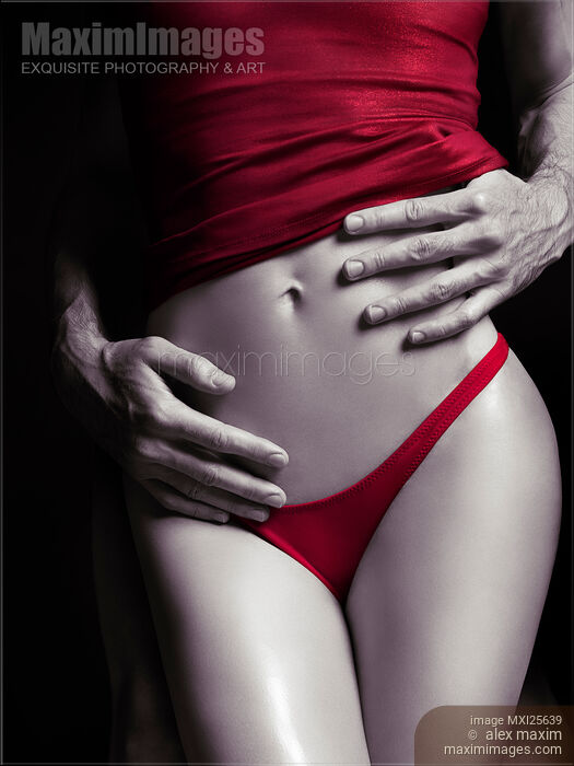 Stock photo of Sexy couple Man hands embracing woman in red Buy commercial use license at MaximImages