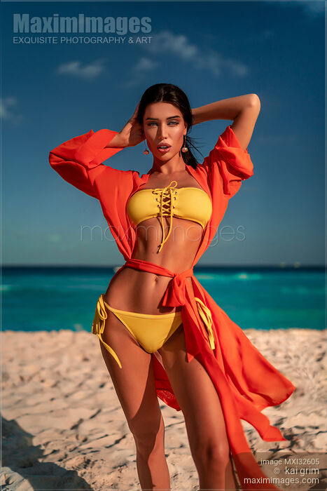 Sexy exotic woman with suntanned skin in a bright bikini swimsuit and a beach robe at Caribbean Sea shore Stock photo of Sexy exotic woman with suntanned skin in a bright bikini swimsuit and a beach robe at Caribbean Sea shore Buy commercial use license at MaximImages
