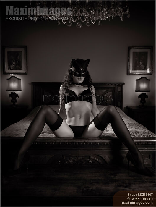Sexy girl in cat mask black lingerie and stockings reclining on antique bed in seductive provocative pose. Black and white. Stock photo of Sexy girl in cat mask black lingerie and stockings reclining on antique bed in seductive provocative pose. Black and white. Buy commercial use license at MaximImages