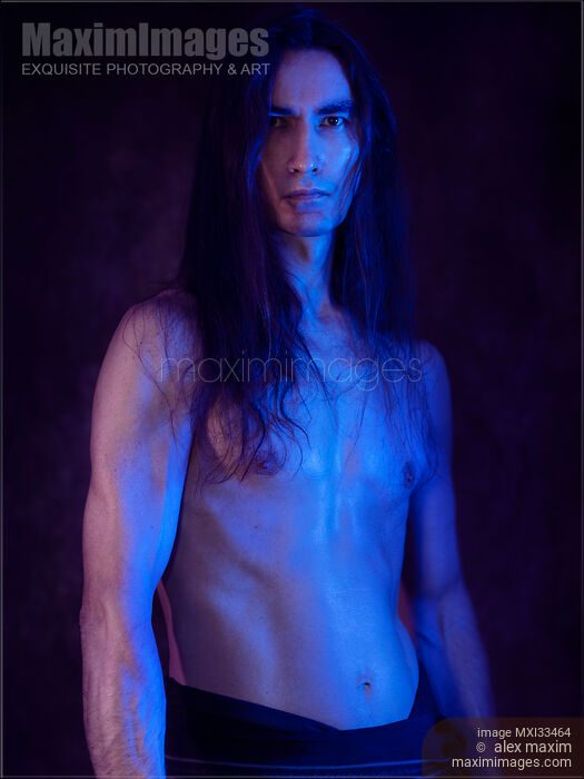 Stock photo of Sexy Japanese warrior with bare sweaty torso artistic portrait in dramatic blue and purple light Buy commercial use license at MaximImages