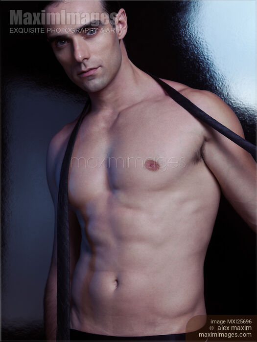 Sexy muscular man taking off necktie Stock photo of Sexy muscular man taking off necktie Buy commercial use license at MaximImages