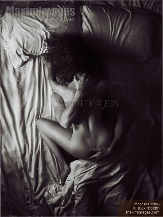 Stock photo of Sexy naked couple making love in bed overhead art nude black and white photo Buy commercial use license at MaximImages