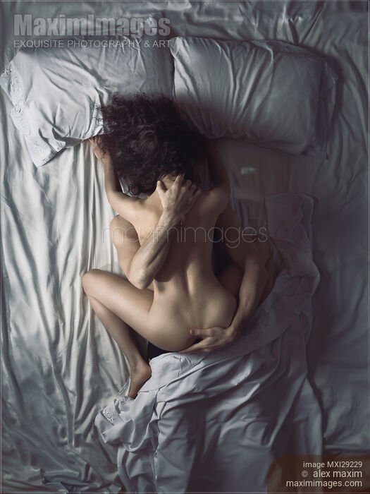 Sexy nude couple making love in bed artistic overhead photo of a woman on top of a man Stock photo of Sexy nude couple making love in bed artistic overhead photo of a woman on top of a man Buy commercial use license at MaximImages