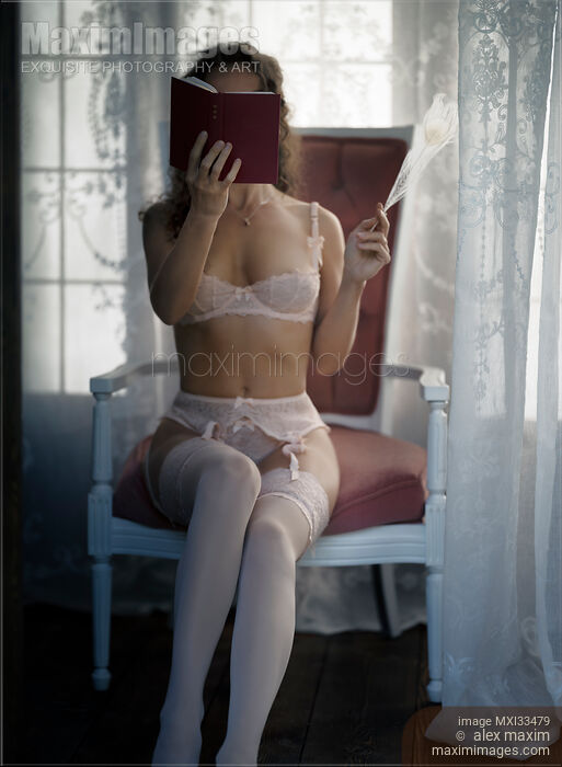 Sexy woman in pink lingerie and stockings sitting in an antique chair reading a little book by a window Stock photo of Sexy woman in pink lingerie and stockings sitting in an antique chair reading a little book by a window Buy commercial use license at MaximImages