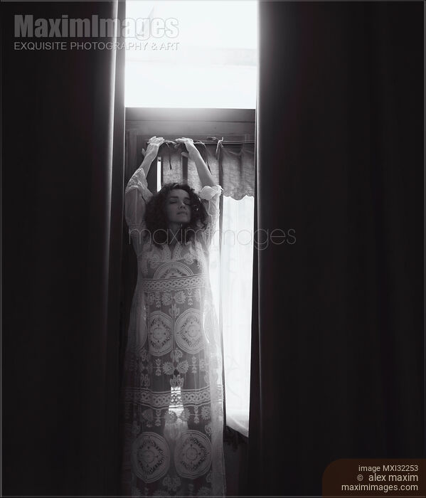 Sexy woman in see-through nightgown standing by the window in a seductive pose Black and white Stock photo of Sexy woman in see-through nightgown standing by the window in a seductive pose Black and white Buy commercial use license at MaximImages