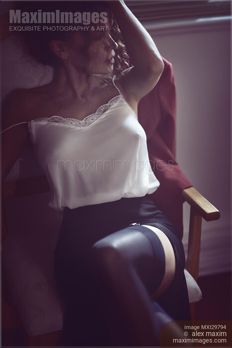 Sexy woman sitting in chair half dressed in night shirt and stockings Stock photo of Sexy woman sitting in chair half dressed in night shirt and stockings Buy commercial use license at MaximImages