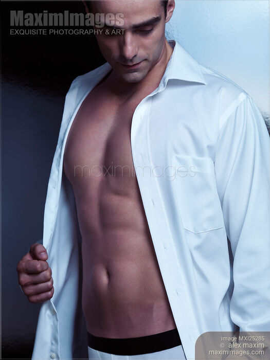 Stock photo of Sexy young man in unbuttoned shirt Buy commercial use license at MaximImages