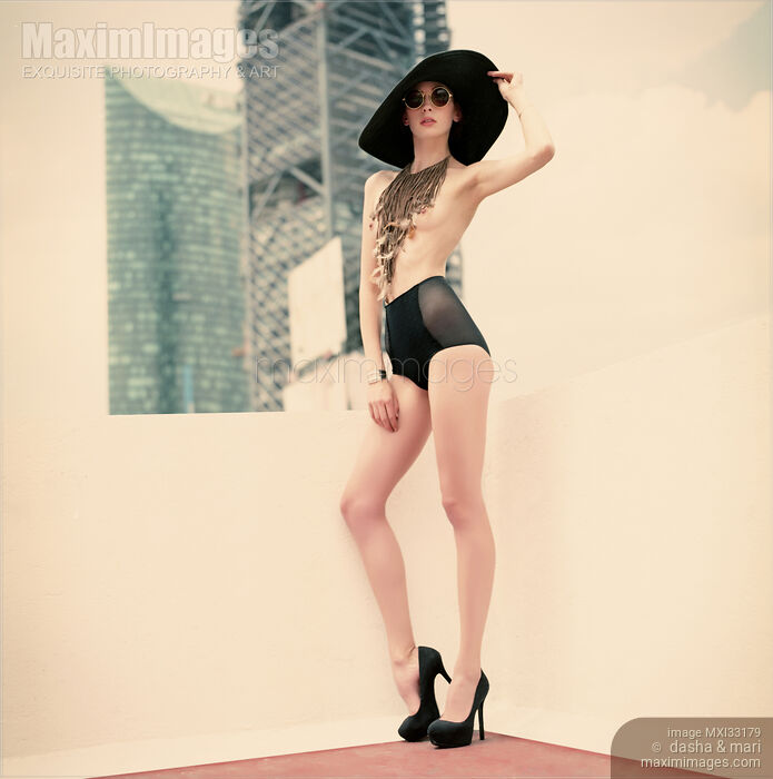 Sexy young woman in black underwear and high heels standing on a rooftop of a city building Stock photo of Sexy young woman in black underwear and high heels standing on a rooftop of a city building Buy commercial use license at MaximImages
