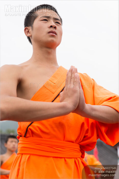 Stock photo of Shaolin Kung Fu student with folded hands in China Buy commercial use license at MaximImages