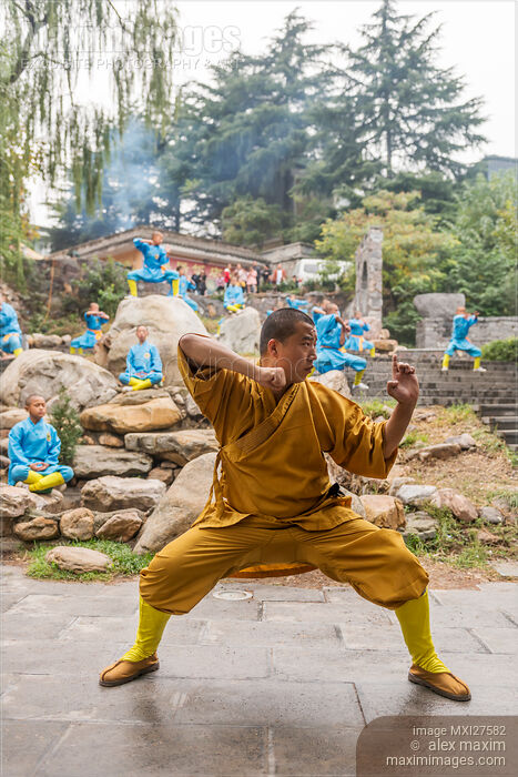 Stock photo of Shaolin martial arts school ShiFu and students practicing Qi Gong outside Buy commercial use license at MaximImages