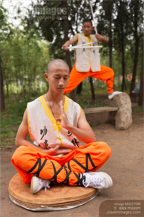 Stock photo of Shaolin martial arts school student meditating outside Buy commercial use license at MaximImages