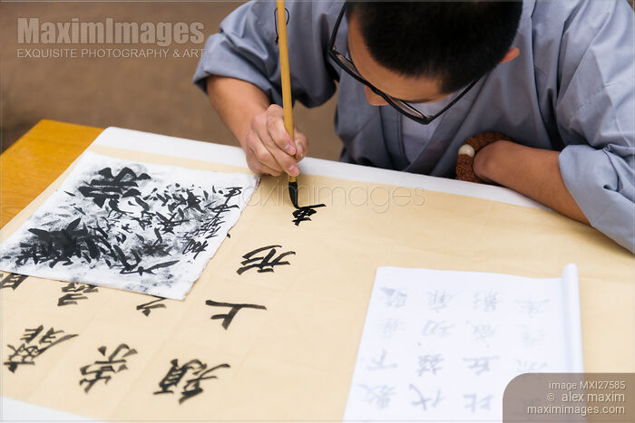 Stock photo of Shaolin martial arts school student practicing Chinese calligraphy Buy commercial use license at MaximImages