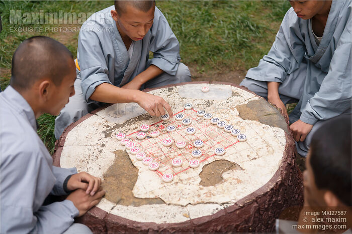 Stock photo of Shaolin martial arts school students playing Xiangqi Chinese chess Buy commercial use license at MaximImages