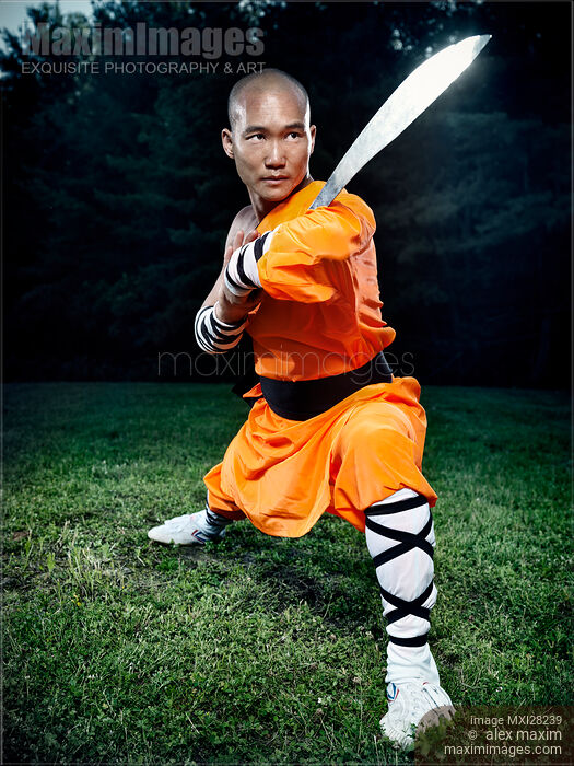 Shaolin warrior monk holding a stance with a broad sword Stock photo of Shaolin warrior monk holding a stance with a broad sword Buy commercial use license at MaximImages