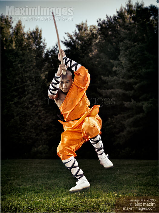 Shaolin warrior monk jumping with a staff Stock photo of Shaolin warrior monk jumping with a staff Buy commercial use license at MaximImages