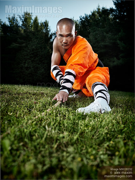 Stock photo of Shaolin warrior monk practicing staff Buy commercial use license at MaximImages