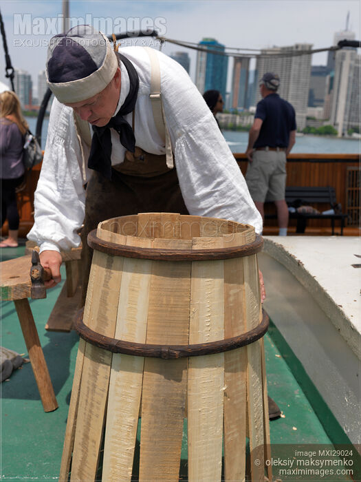 Stock photo of Ship Carpenter Assembling a Barrel Buy commercial use license at MaximImages