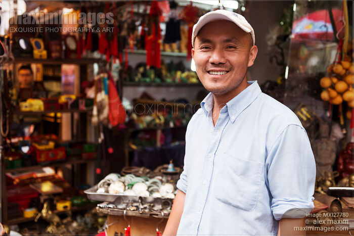 Stock photo of Shop owner at antique market in Shanghai, China Buy commercial use license at MaximImages