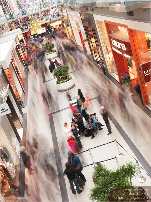 Stock photo of Shoppers blurred from motion at Toronto Eaton Centre shopping mall Buy commercial use license at MaximImages