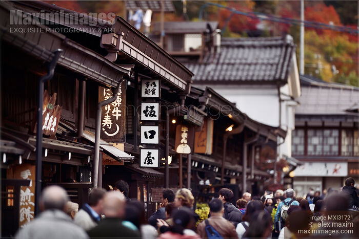 Signs of shops and restaurants at Kami-Sannomachi old town market street of Hida-Takayama busy with people Stock photo of Signs of shops and restaurants at Kami-Sannomachi old town market street of Hida-Takayama busy with people Buy commercial use license at MaximImages
