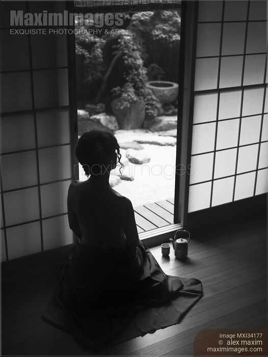 Silhouette of a woman with bared back sitting inside by an open Shoji door looking at Japanese Zen garden. Black and white. Stock photo of Silhouette of a woman with bared back sitting inside by an open Shoji door looking at Japanese Zen garden. Black and white. Buy commercial use license at MaximImages