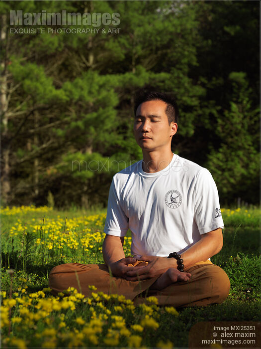 Stock photo of Sitting Buddhist meditation in the nature Buy commercial use license at MaximImages