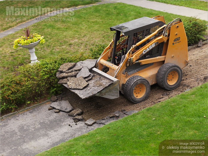 Stock photo of Skid Steer Loader Removing Pavement Buy commercial use license at MaximImages