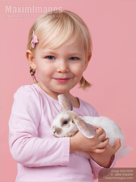 Stock photo of Smiling girl with a bunny in hands Buy commercial use license at MaximImages