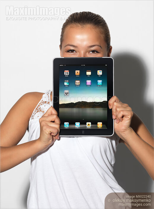 Stock photo of Smiling Girl with Apple iPad 3G Tablet Buy commercial use license at MaximImages