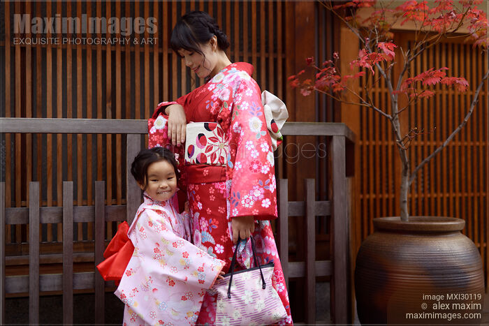 Smiling little girl and her mother dressed in red kimonos on the street in Gion Kyoto Japan Stock photo of Smiling little girl and her mother dressed in red kimonos on the street in Gion Kyoto Japan Buy commercial use license at MaximImages